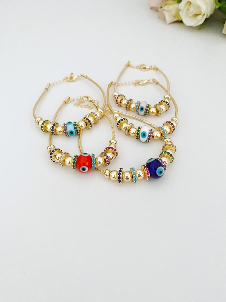 A beautiful Evil Eye Bracelet featuring a colorful glass charm and adjustable stainless steel design, perfect for everyday wear and protection.