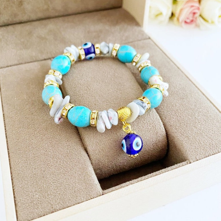 A beautiful Evil Eye Bracelet featuring baroque beads, turquoise beads, and blue glass eye beads, showcasing a boho style.