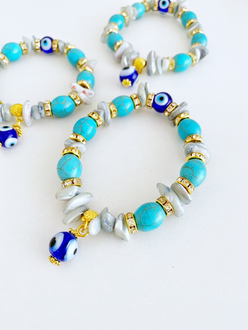 A beautiful Evil Eye Bracelet featuring baroque beads, turquoise beads, and blue glass eye beads, showcasing a boho style.