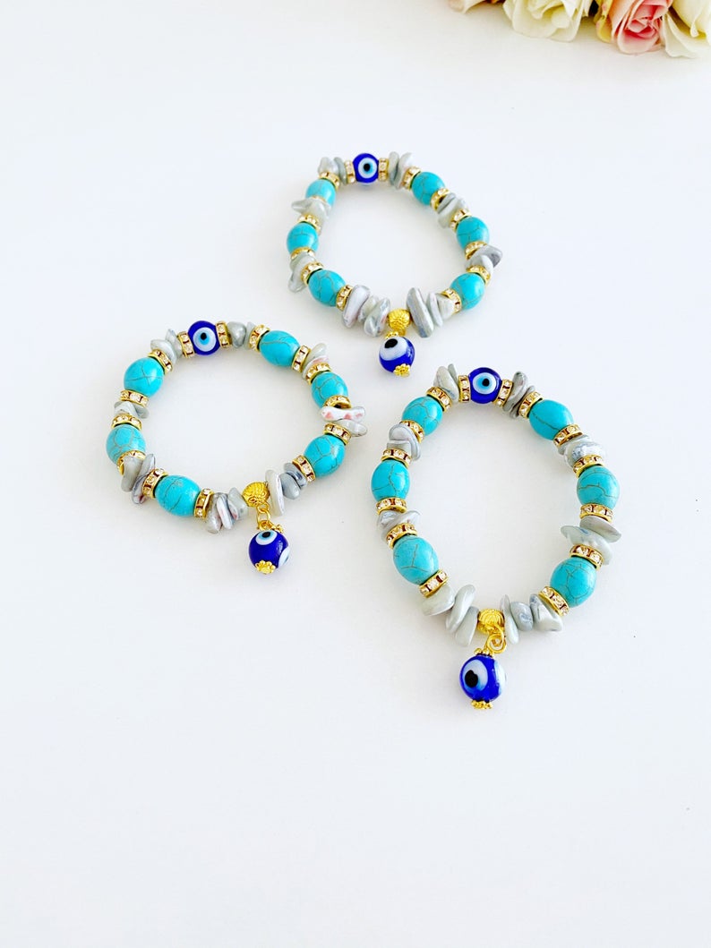 A beautiful Evil Eye Bracelet featuring baroque beads, turquoise beads, and blue glass eye beads, showcasing a boho style.