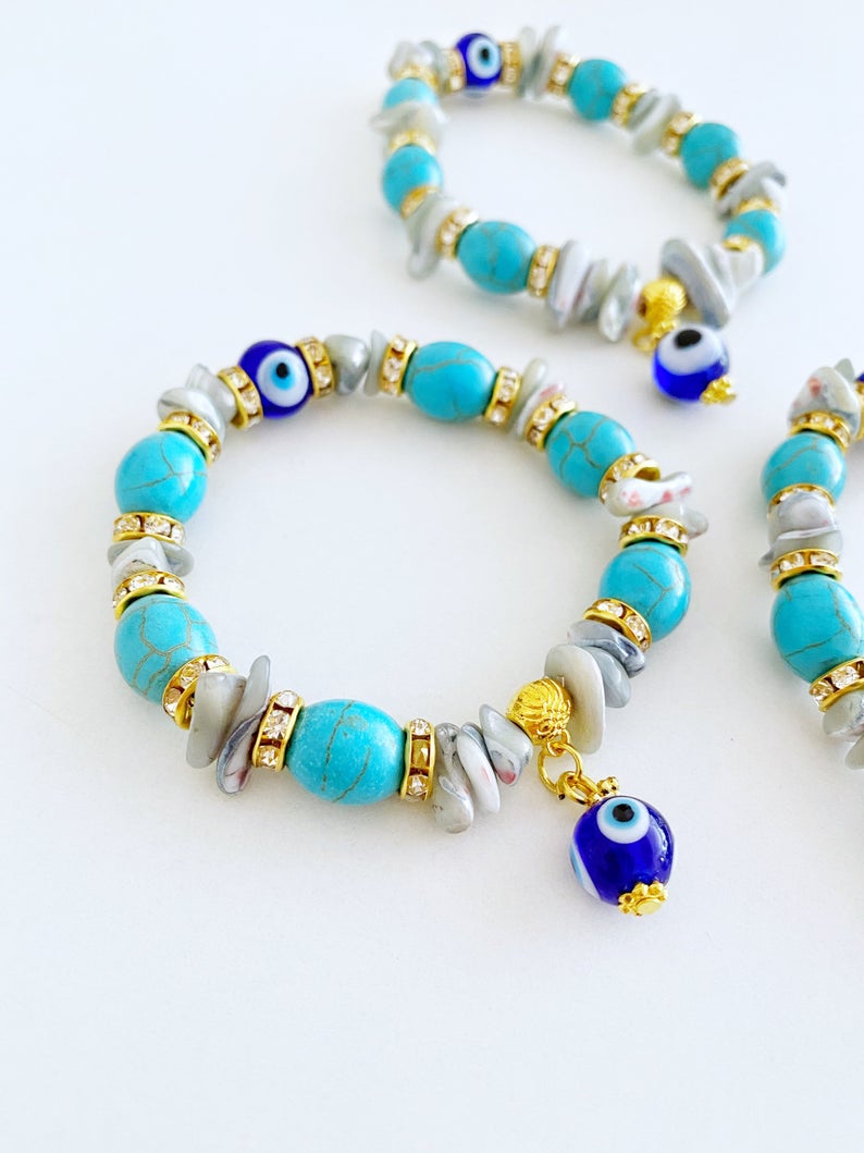 A beautiful Evil Eye Bracelet featuring baroque beads, turquoise beads, and blue glass eye beads, showcasing a boho style.
