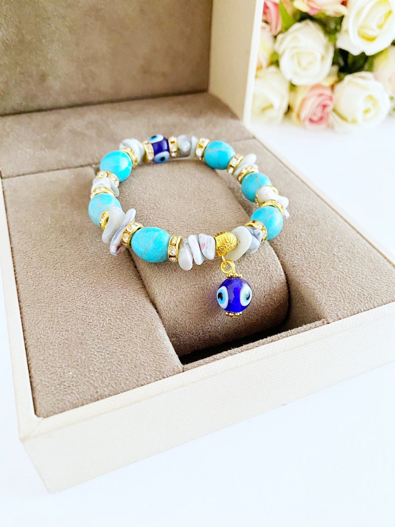 A beautiful Evil Eye Bracelet featuring baroque beads, turquoise beads, and blue glass eye beads, showcasing a boho style.