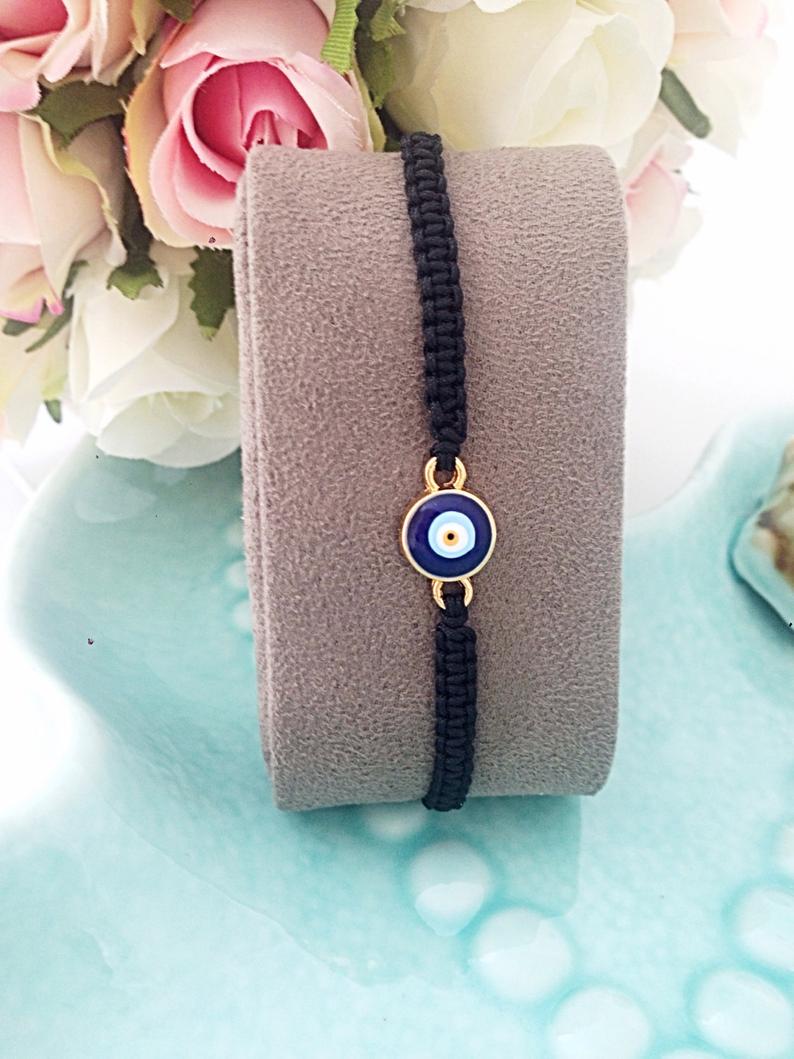 Handmade Evil Eye Bracelet featuring a black macramé thread and a blue Turkish evil eye bead, adjustable for all wrist sizes.