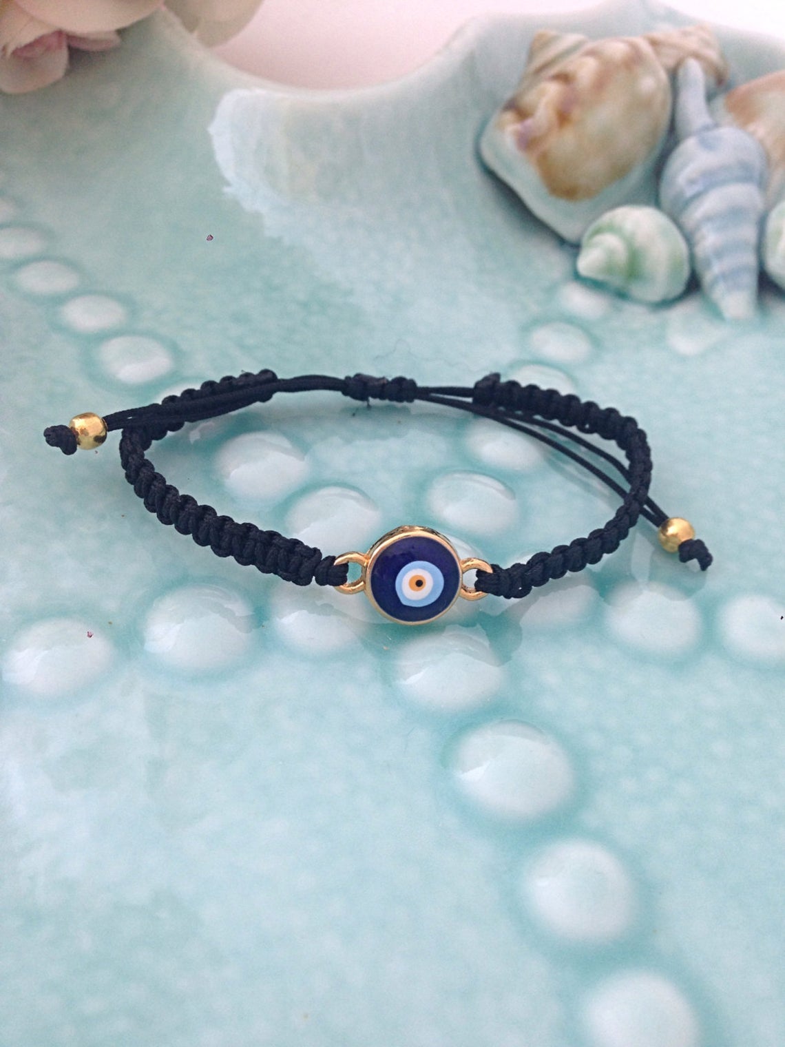 Handmade Evil Eye Bracelet featuring a black macramé thread and a blue Turkish evil eye bead, adjustable for all wrist sizes.
