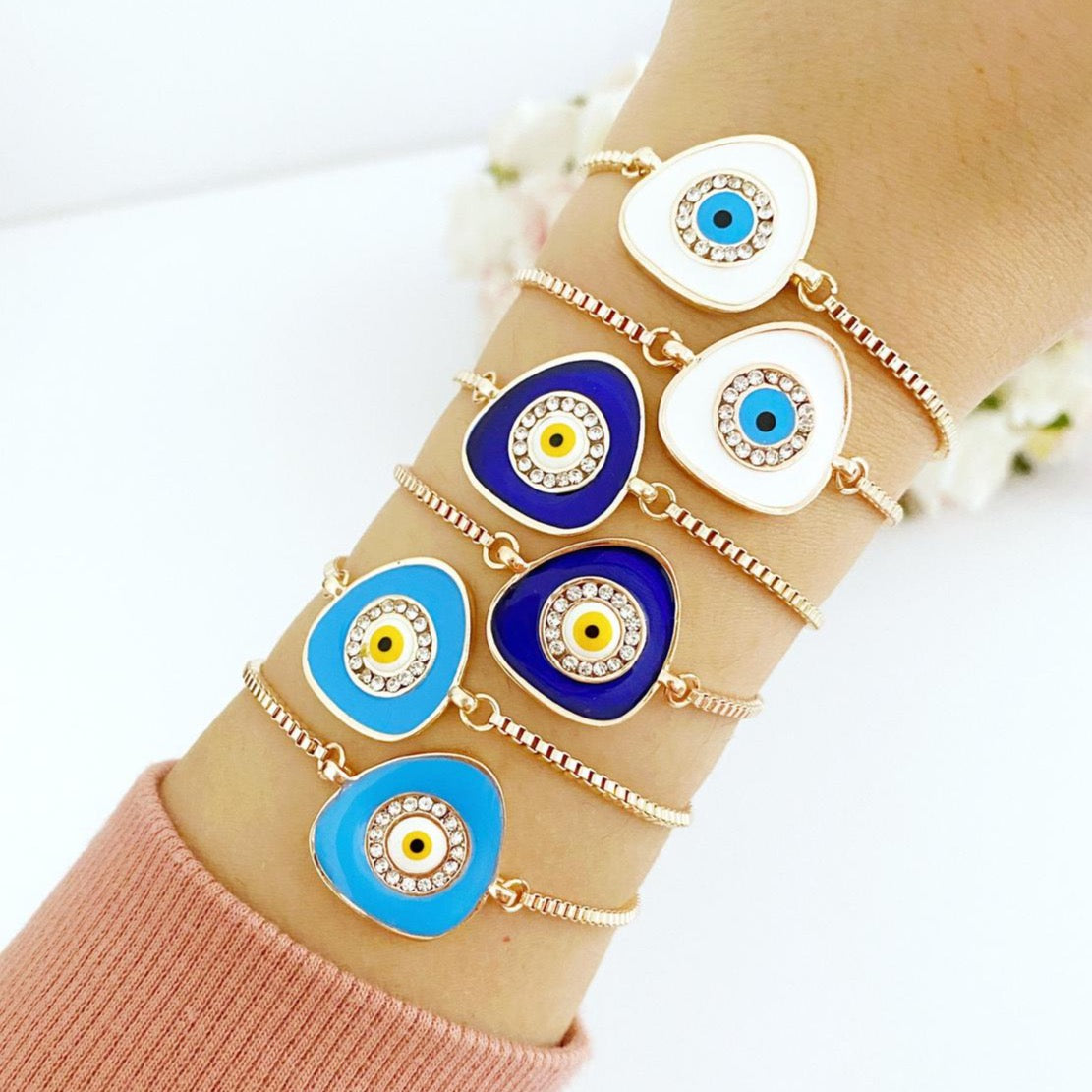 A beautiful Evil Eye Bracelet featuring a blue charm on an adjustable rose gold chain, showcasing its elegant design and protective symbolism.
