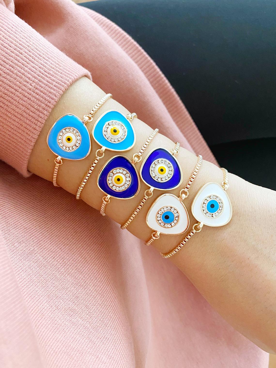 A beautiful Evil Eye Bracelet featuring a blue charm on an adjustable rose gold chain, showcasing its elegant design and protective symbolism.