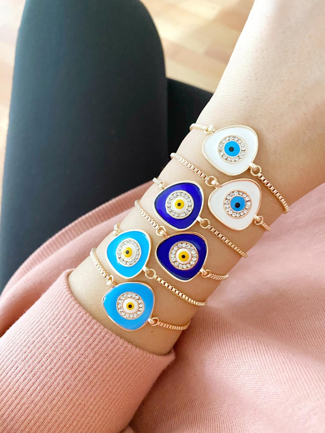 A beautiful Evil Eye Bracelet featuring a blue charm on an adjustable rose gold chain, showcasing its elegant design and protective symbolism.