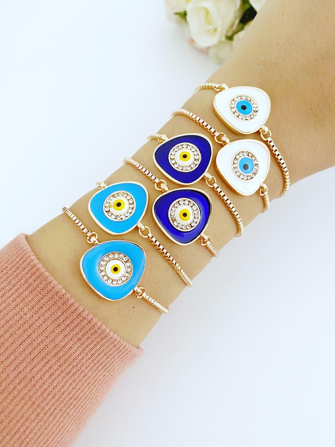 A beautiful Evil Eye Bracelet featuring a blue charm on an adjustable rose gold chain, showcasing its elegant design and protective symbolism.