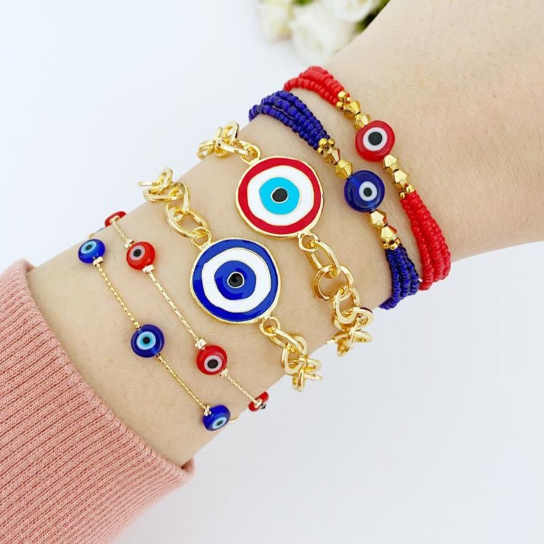 Evil Eye Bracelet featuring blue and red beads on a gold chain, showcasing its handmade craftsmanship and adjustable design.