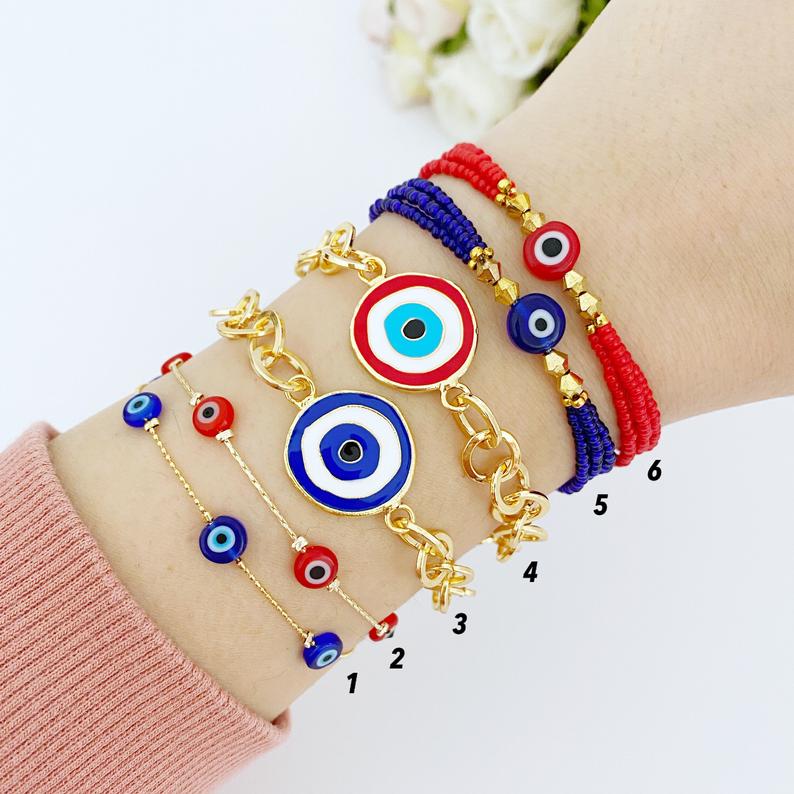 Evil Eye Bracelet featuring blue and red beads on a gold chain, showcasing its handmade craftsmanship and adjustable design.