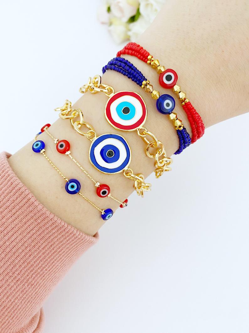 Evil Eye Bracelet featuring blue and red beads on a gold chain, showcasing its handmade craftsmanship and adjustable design.
