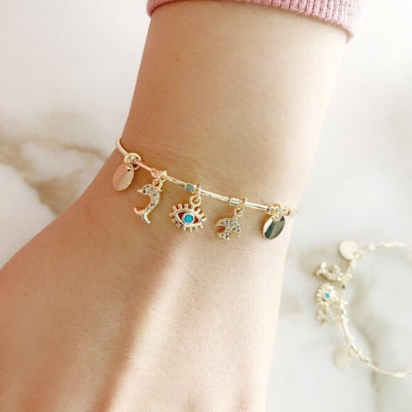 A delicate gold Evil Eye Bracelet featuring cubic zirconia dangles, made from tarnish-resistant 316L stainless steel.