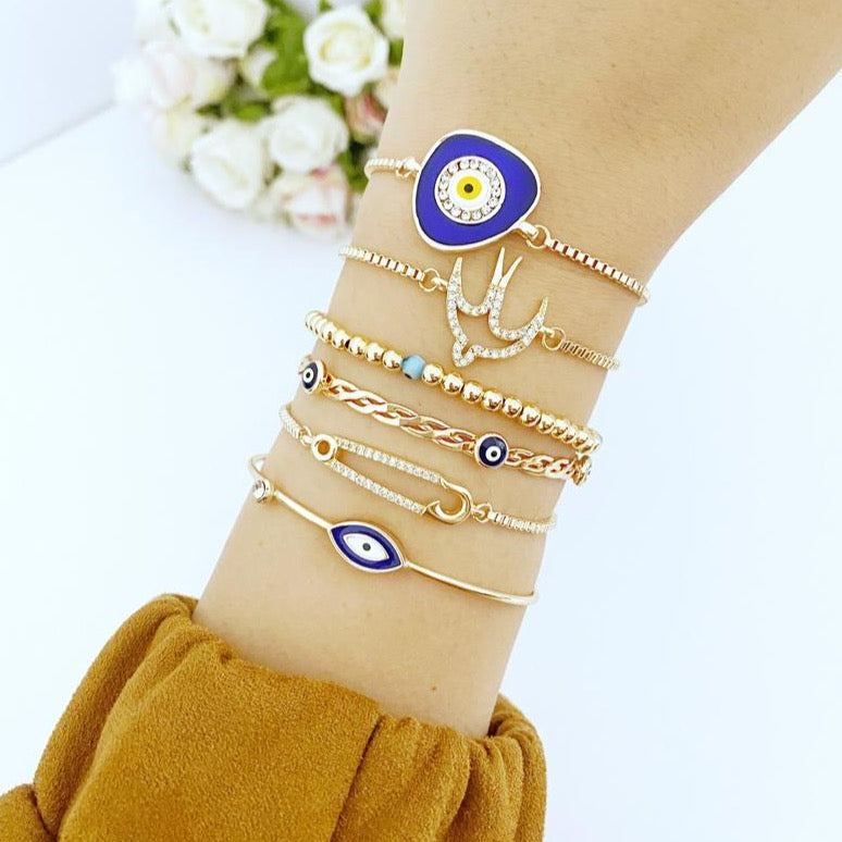 Gold adjustable Evil Eye Bracelet featuring a bird charm, handmade with tarnish-resistant stainless steel.