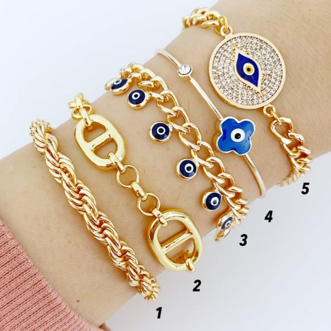 A beautiful Evil Eye Bracelet featuring a chunky gold chain and a blue evil eye charm, symbolizing protection and style.
