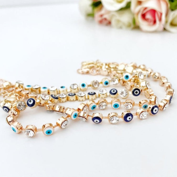 Elegant Evil Eye Bracelet featuring a gold link chain and blue-white evil eye bead, perfect for protection and style.