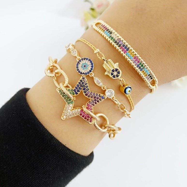 A beautiful Evil Eye Bracelet featuring a gold link chain, adjustable design, and handmade craftsmanship, showcasing its unique styles.