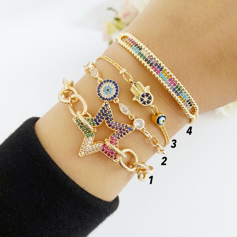 A beautiful Evil Eye Bracelet featuring a gold link chain, adjustable design, and handmade craftsmanship, showcasing its unique styles.