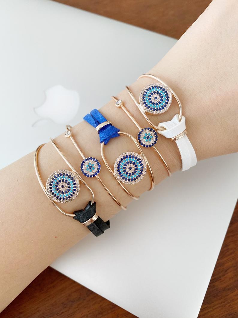 Evil Eye Bracelet featuring a leather band and rose gold chain, adorned with a protective evil eye charm and zircon stones.