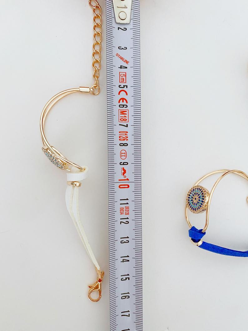 Evil Eye Bracelet featuring a leather band and rose gold chain, adorned with a protective evil eye charm and zircon stones.