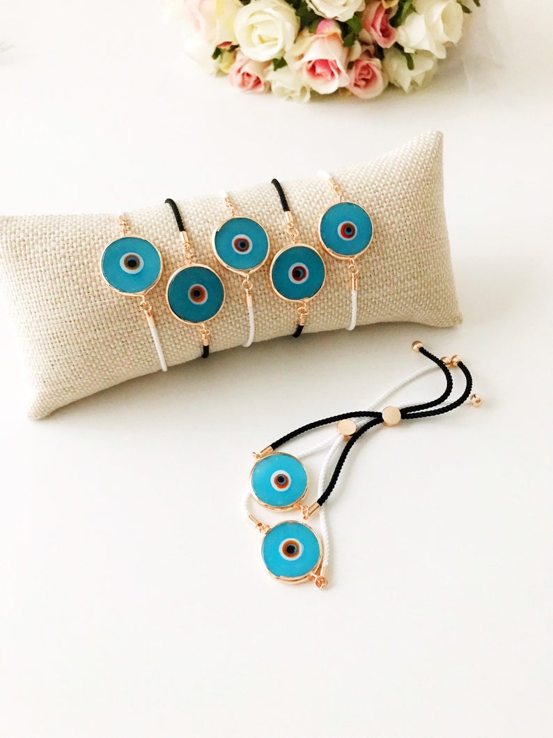 Handmade adjustable Evil Eye Bracelet featuring a 20mm baby blue Murano bead on a white string, symbolizing protection and style.