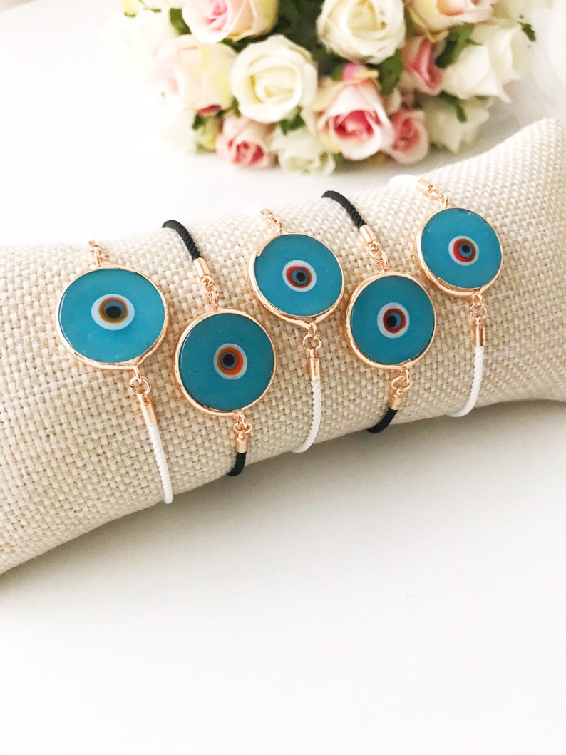 Handmade adjustable Evil Eye Bracelet featuring a 20mm baby blue Murano bead on a white string, symbolizing protection and style.