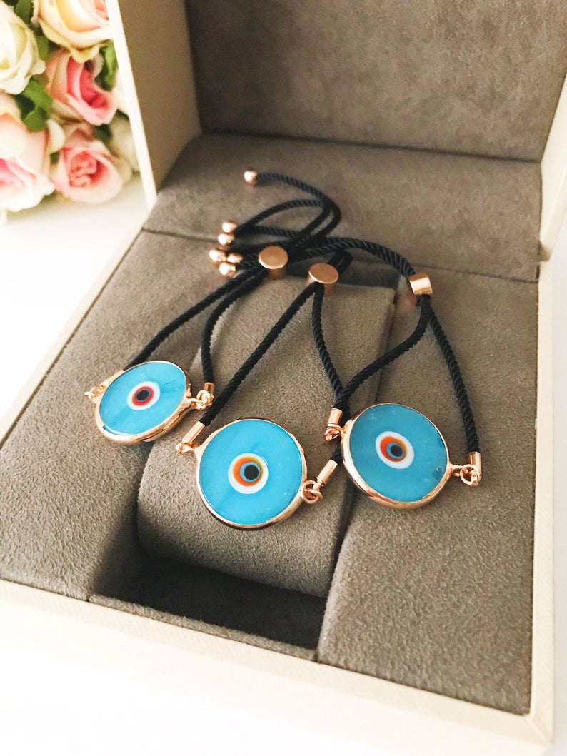 Handmade adjustable Evil Eye Bracelet featuring a 20mm baby blue Murano bead on a white string, symbolizing protection and style.