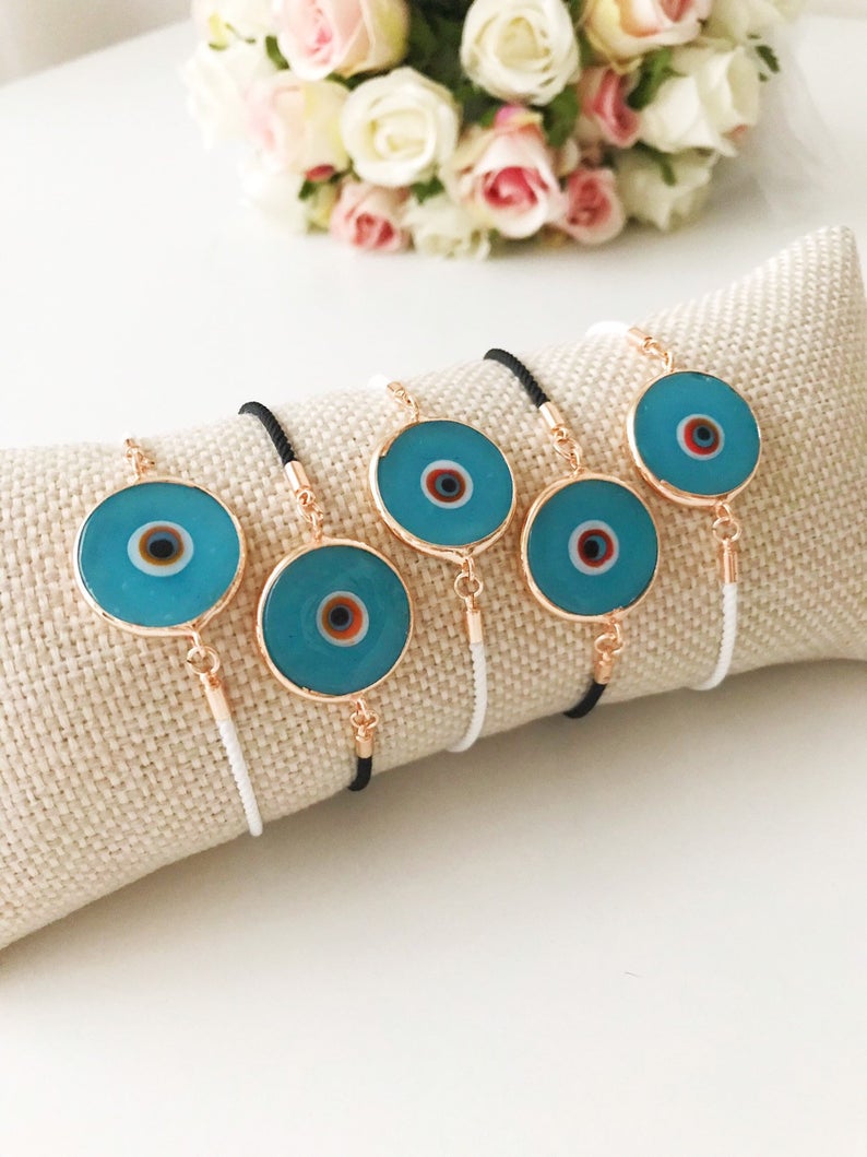 Handmade adjustable Evil Eye Bracelet featuring a 20mm baby blue Murano bead on a white string, symbolizing protection and style.