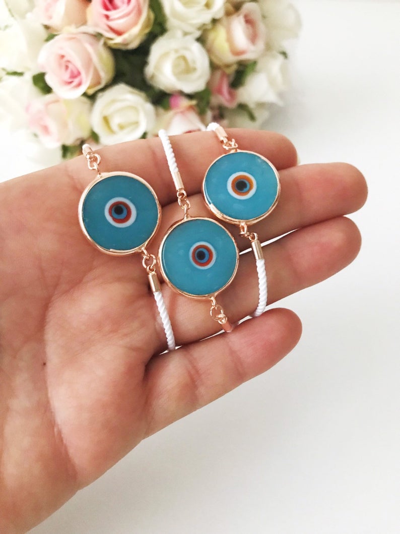 Handmade adjustable Evil Eye Bracelet featuring a 20mm baby blue Murano bead on a white string, symbolizing protection and style.