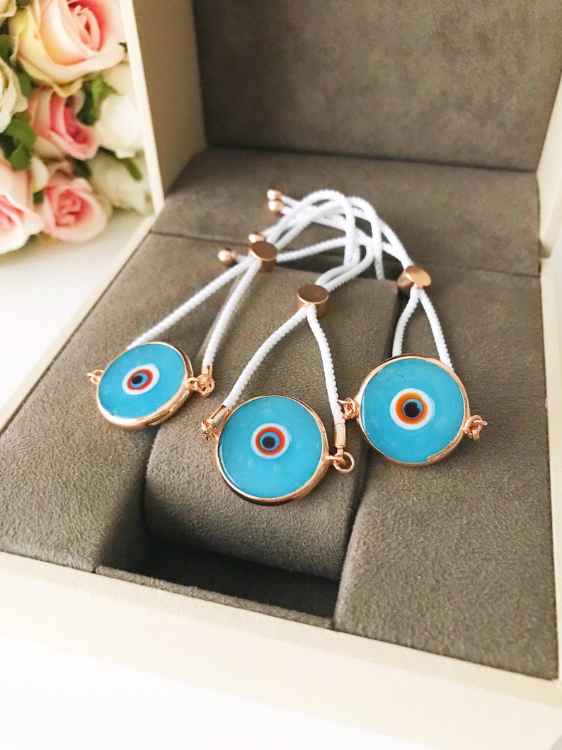 Handmade adjustable Evil Eye Bracelet featuring a 20mm baby blue Murano bead on a white string, symbolizing protection and style.