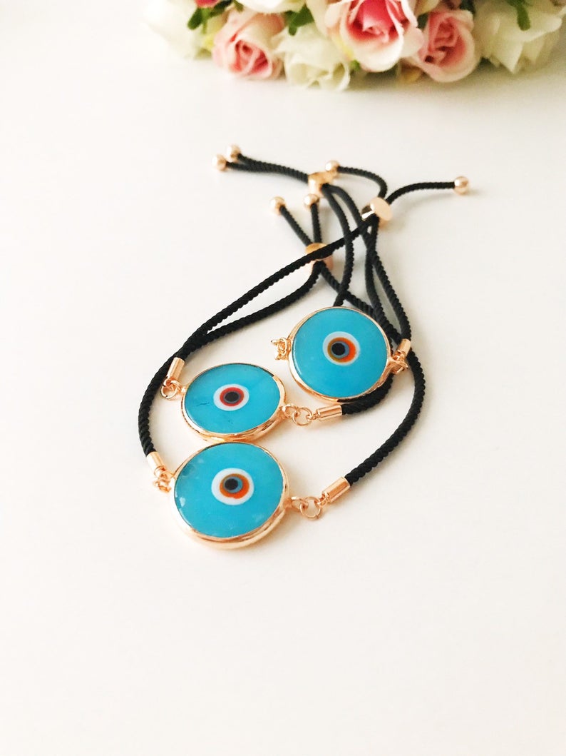 Handmade adjustable Evil Eye Bracelet featuring a 20mm baby blue Murano bead on a white string, symbolizing protection and style.