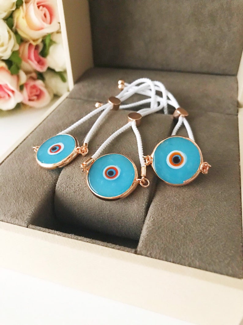 Handmade adjustable Evil Eye Bracelet featuring a 20mm baby blue Murano bead on a white string, symbolizing protection and style.