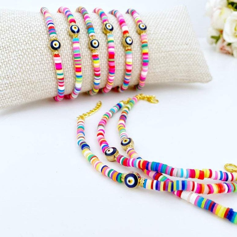 Handmade Evil Eye Bracelet featuring colorful rainbow heishi beads and a protective charm, perfect for beach and bohemian styles.