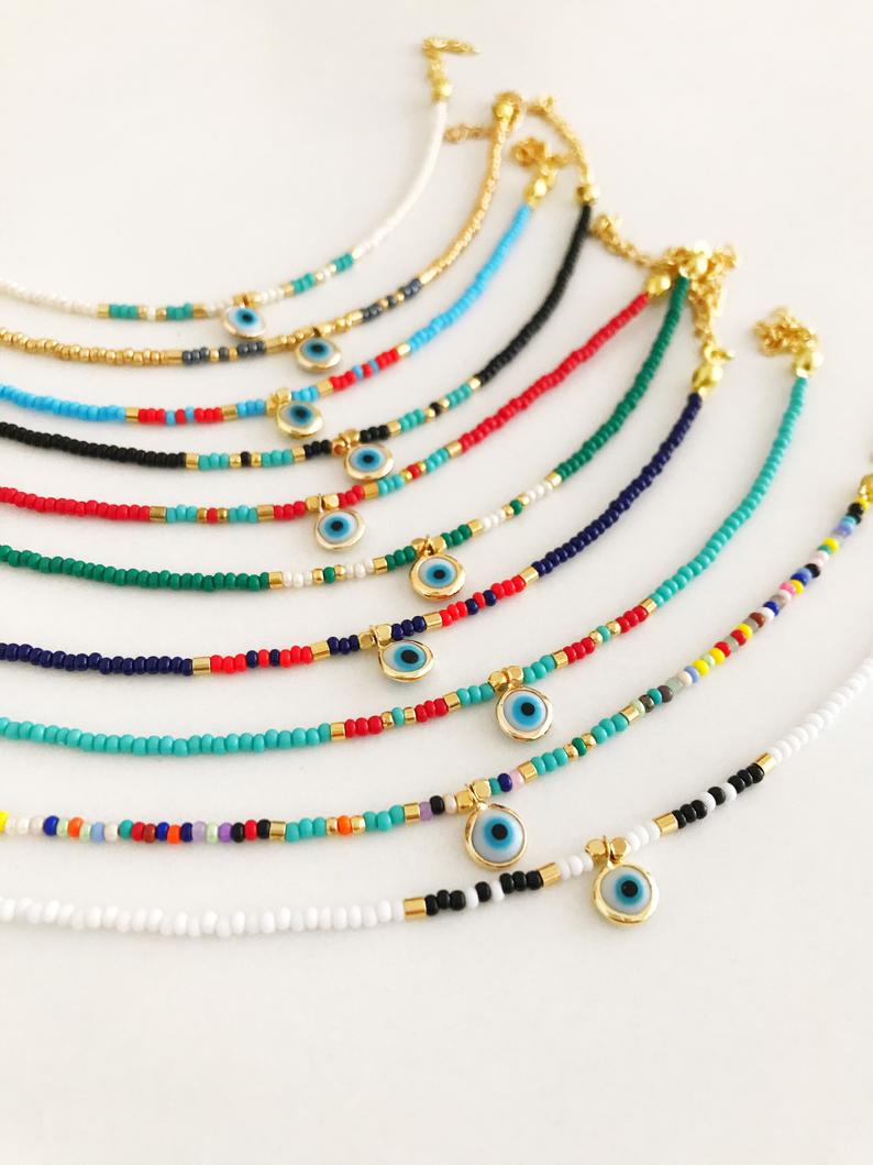Handmade Evil Eye Bracelet featuring colorful seed beads and a blue evil eye bead, symbolizing luck and protection.