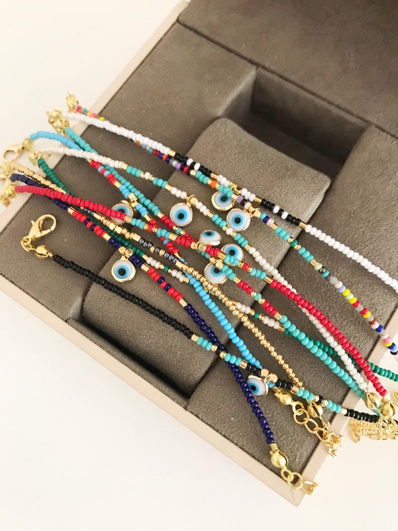 Handmade Evil Eye Bracelet featuring colorful seed beads and a blue evil eye bead, symbolizing luck and protection.