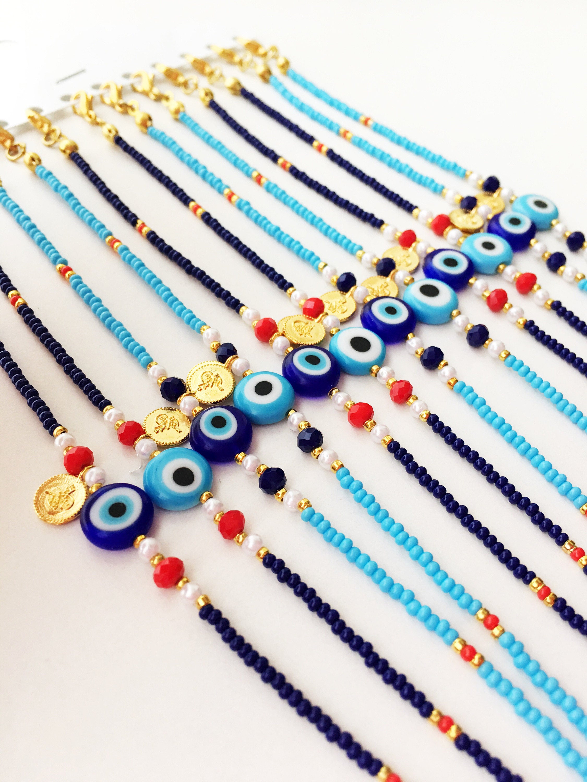 Handmade Evil Eye Bracelet featuring turquoise Miyuki seed beads and a gold charm, symbolizing luck and protection.