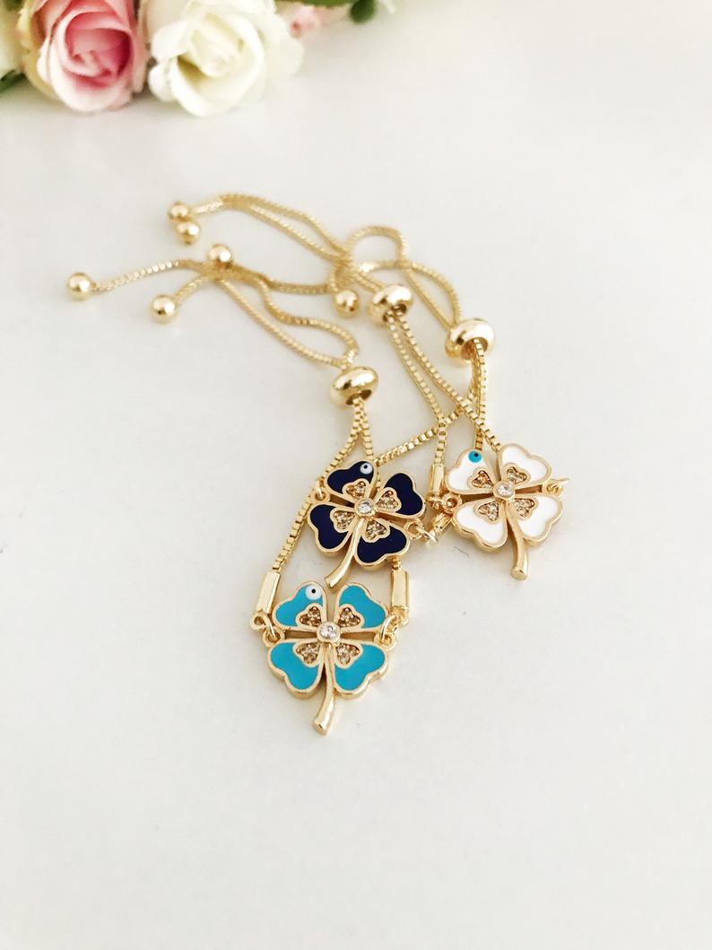 A beautifully crafted Evil Eye Bracelet Set featuring adjustable designs with clover and elephant charms in gold and silver.