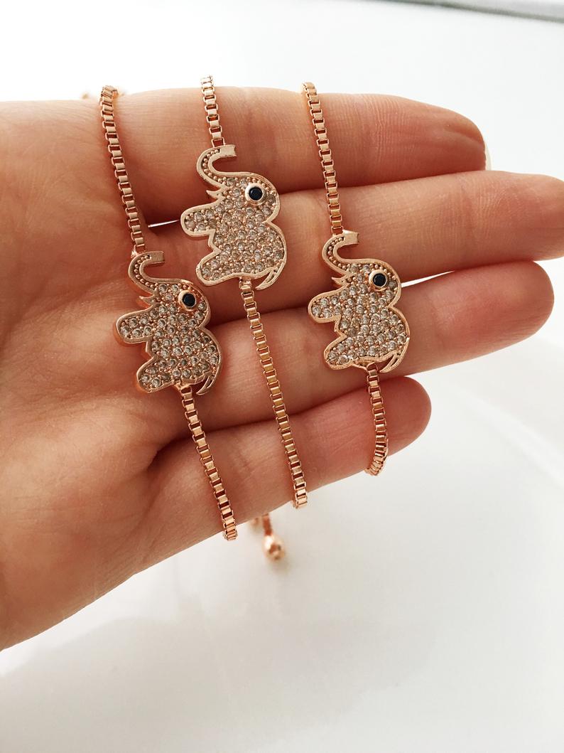 A beautifully crafted Evil Eye Bracelet Set featuring adjustable designs with clover and elephant charms in gold and silver.