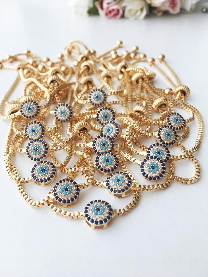 A beautifully crafted Evil Eye Bracelet Set featuring adjustable designs with clover and elephant charms in gold and silver.