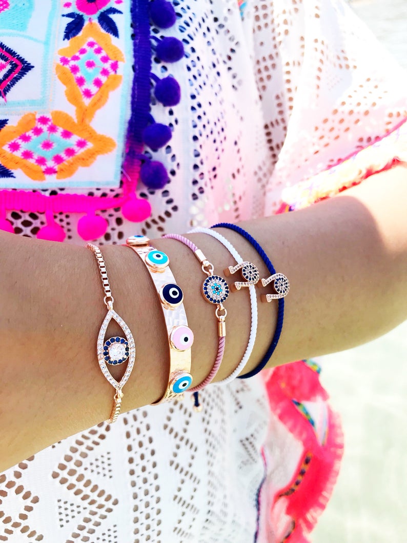 A collection of five unique evil eye bracelets featuring horseshoe charms and adjustable designs, crafted from tarnish-resistant stainless steel.