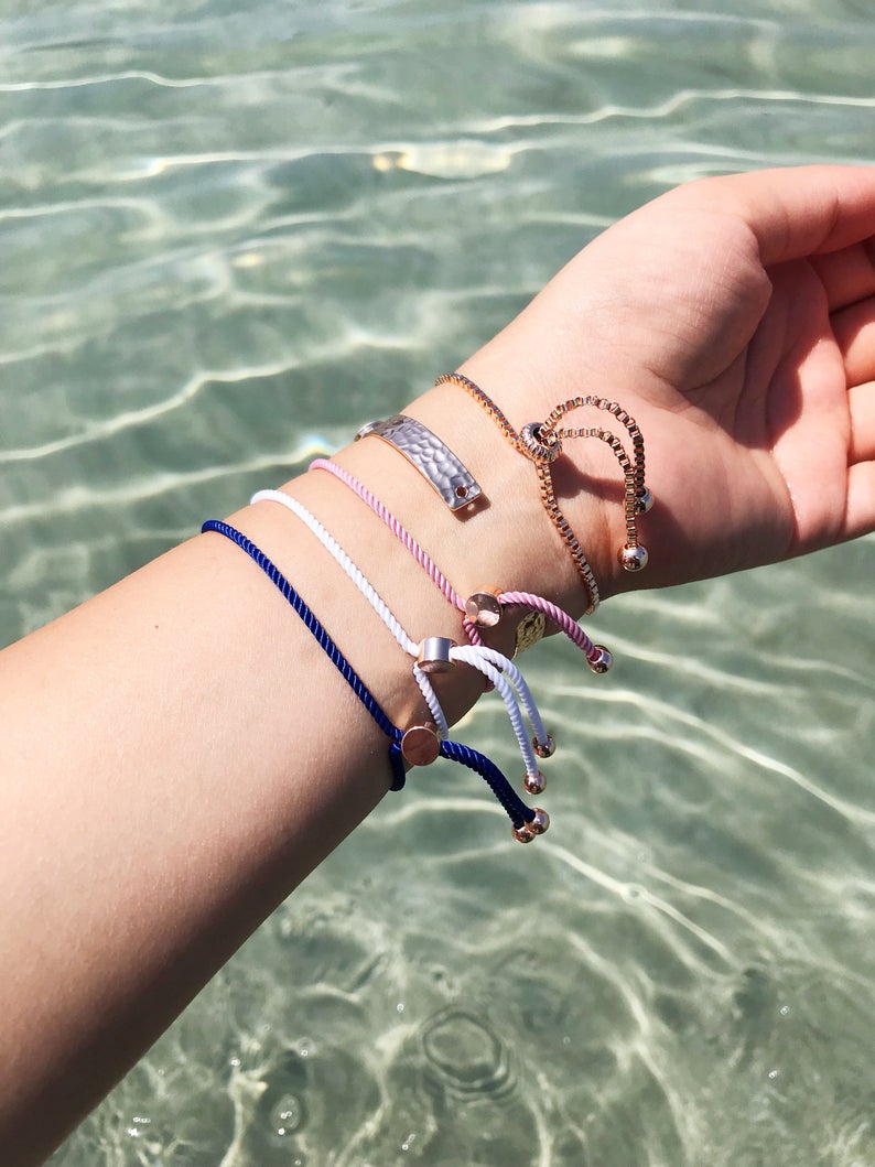 A collection of five unique evil eye bracelets featuring horseshoe charms and adjustable designs, crafted from tarnish-resistant stainless steel.