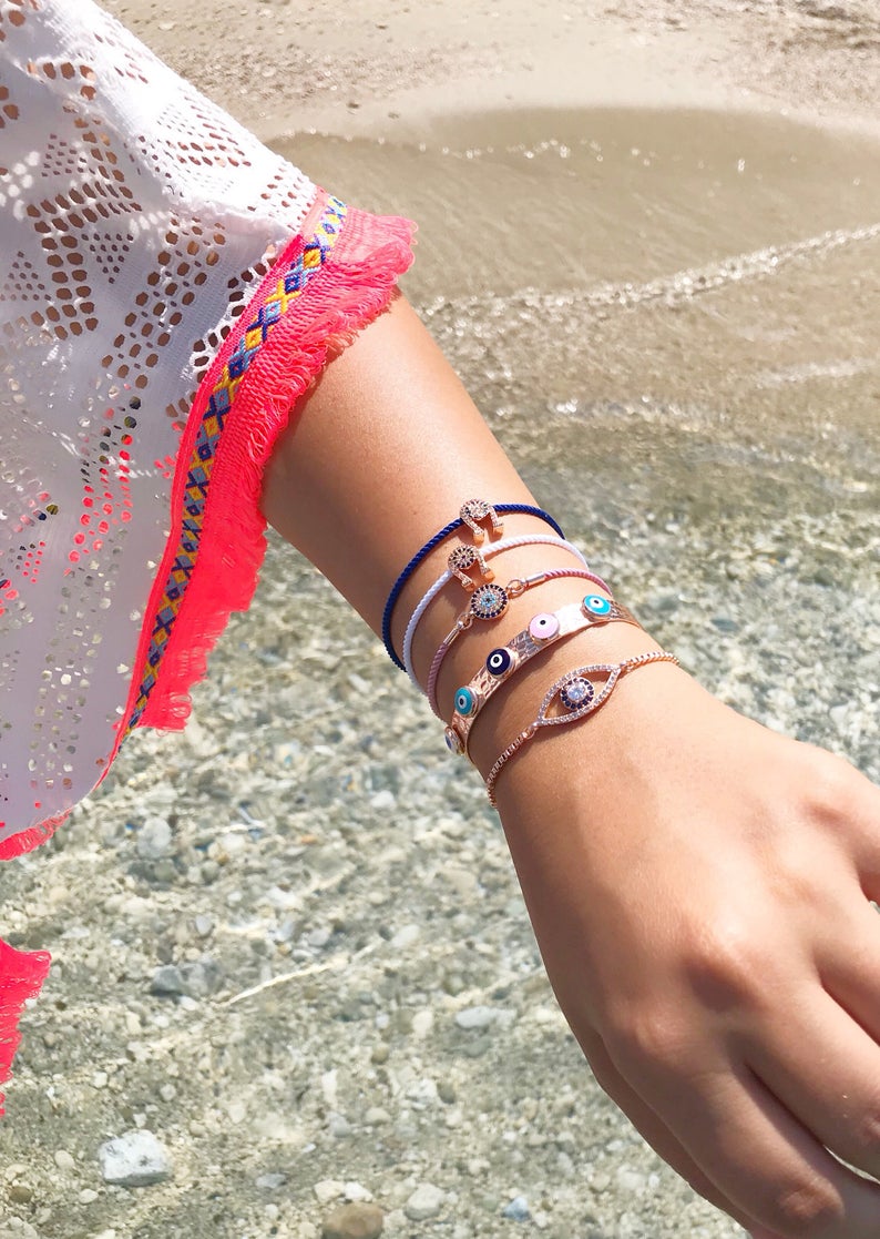 A collection of five unique evil eye bracelets featuring horseshoe charms and adjustable designs, crafted from tarnish-resistant stainless steel.