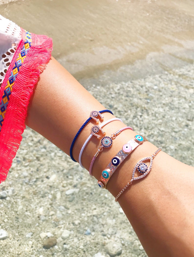 A collection of five unique evil eye bracelets featuring horseshoe charms and adjustable designs, crafted from tarnish-resistant stainless steel.
