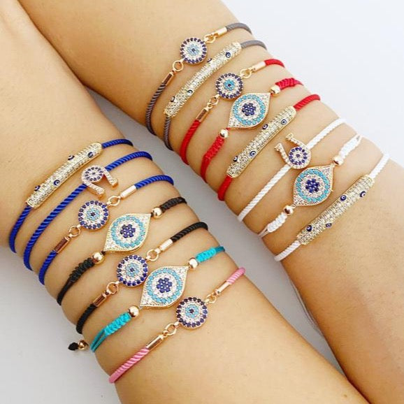 A beautiful adjustable evil eye bracelet featuring zircon charms, crafted from tarnish-resistant stainless steel, showcasing its unique design.