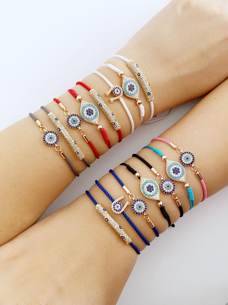 A beautiful adjustable evil eye bracelet featuring zircon charms, crafted from tarnish-resistant stainless steel, showcasing its unique design.
