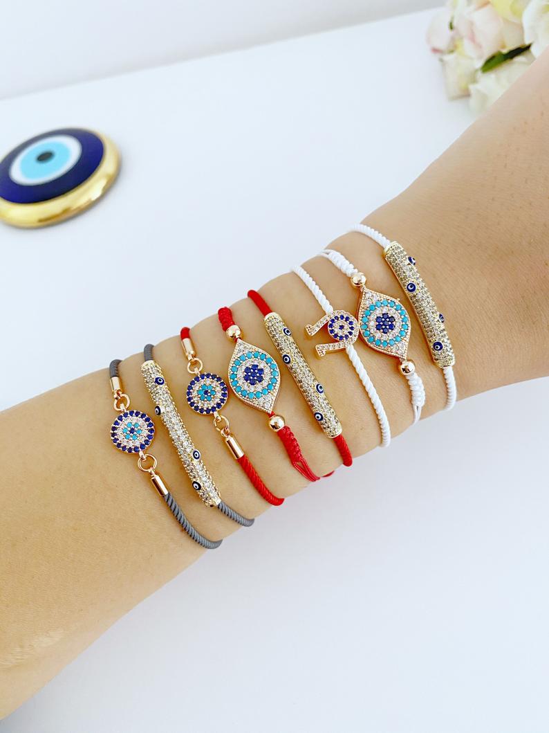 A beautiful adjustable evil eye bracelet featuring zircon charms, crafted from tarnish-resistant stainless steel, showcasing its unique design.