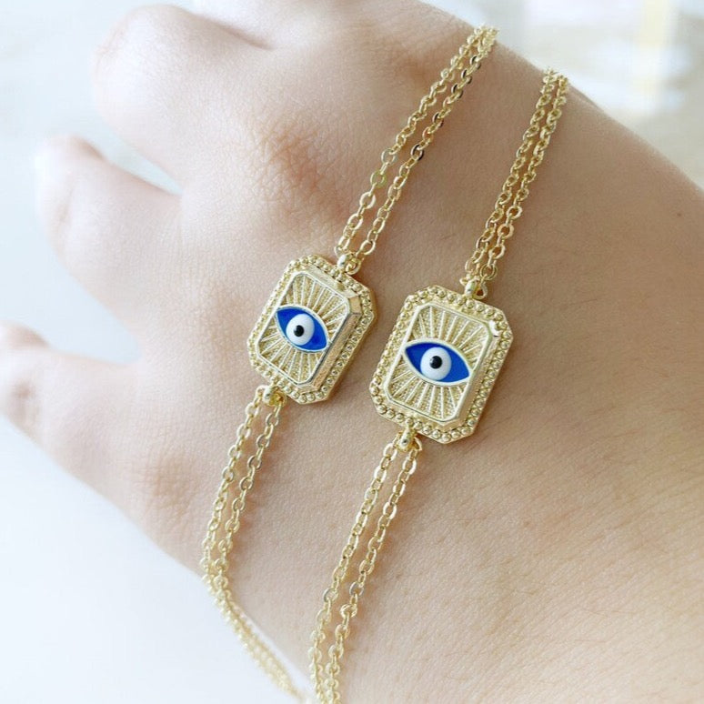 Elegant blue evil eye chain bracelet with double chain design, featuring handmade blue beads for protection and style.