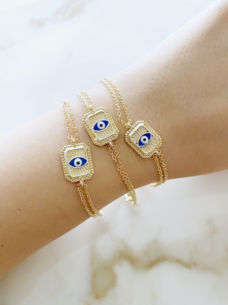 Elegant blue evil eye chain bracelet with double chain design, featuring handmade blue beads for protection and style.