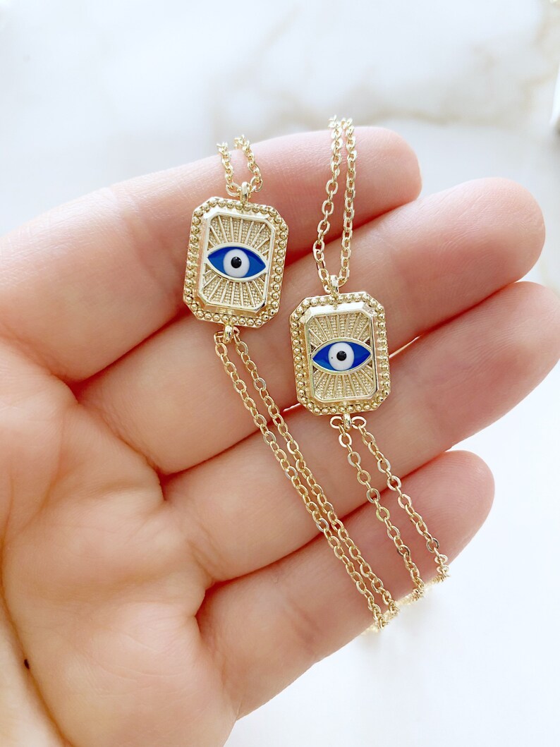 Elegant blue evil eye chain bracelet with double chain design, featuring handmade blue beads for protection and style.