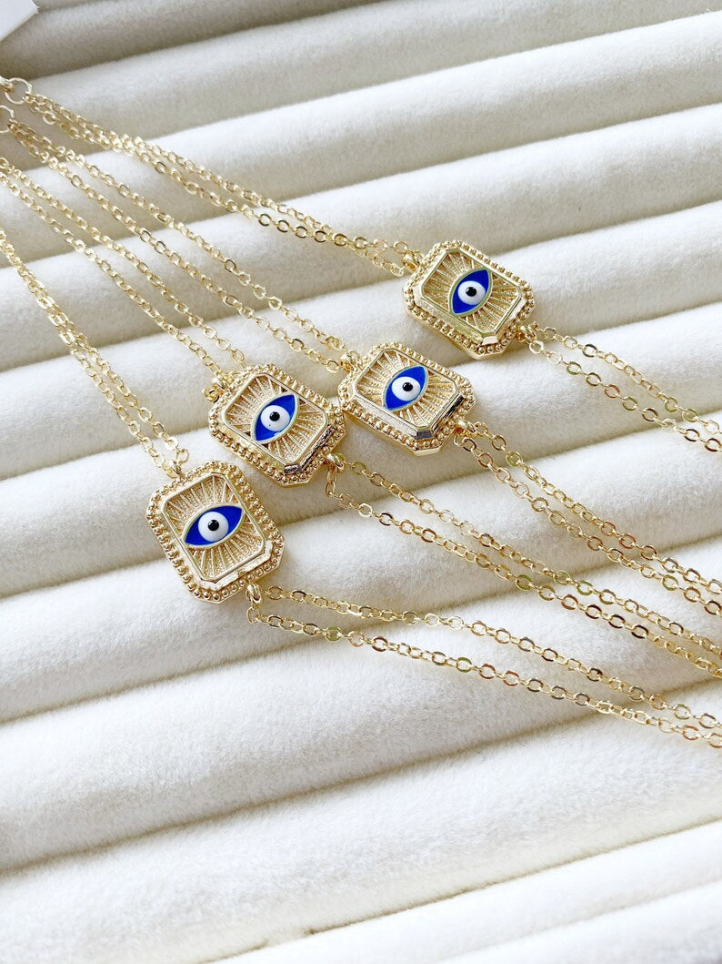 Elegant blue evil eye chain bracelet with double chain design, featuring handmade blue beads for protection and style.