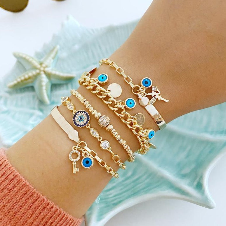Gold Evil Eye Chain Bracelet featuring a blue charm, handmade with adjustable stainless steel for durability and style.